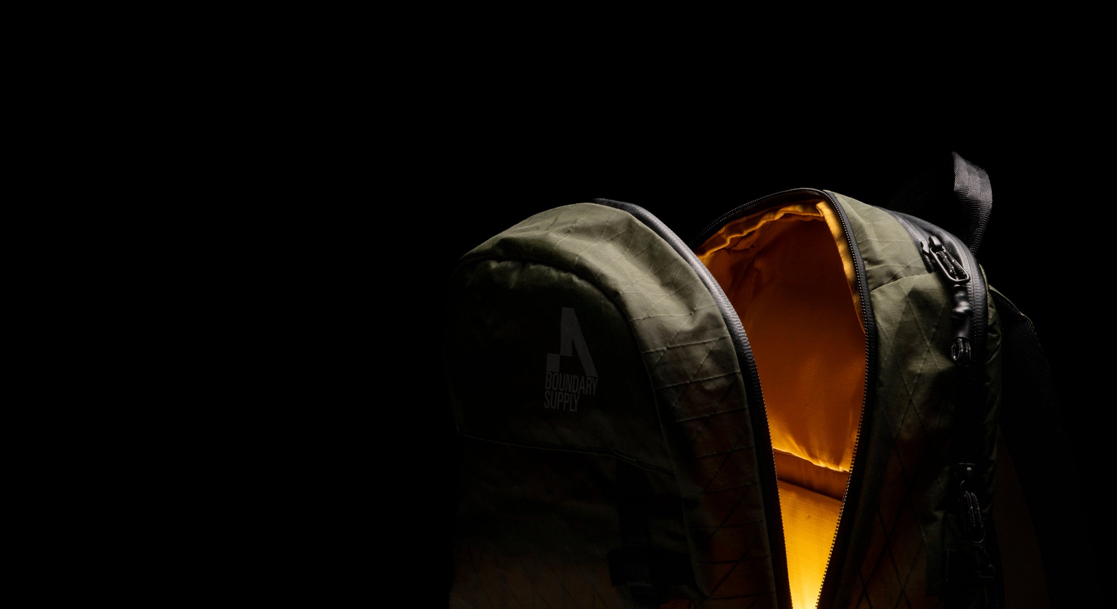 Boundary Supply backpack with illuminated interior and weatherproof zipper in low light setting